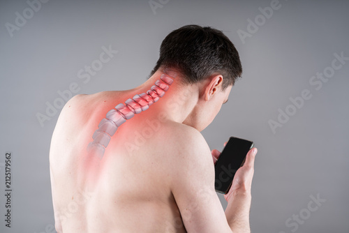 Man with neck pain from using smartphone, text neck and bad posture, painful area highlighted in red, graphic skeleton spine