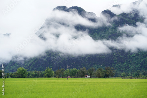 Morning mist over rice fields and rural landscape in Kong Lor Village, Khammouane Province, Laos