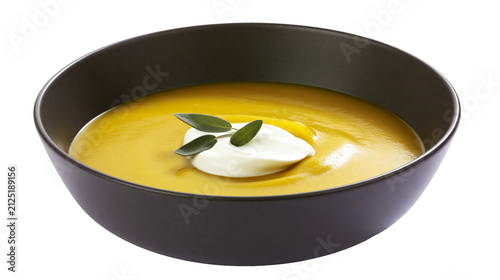 Fotografie Creamy yellow soup with dollop of cream and sage leaves, isolated on transparent