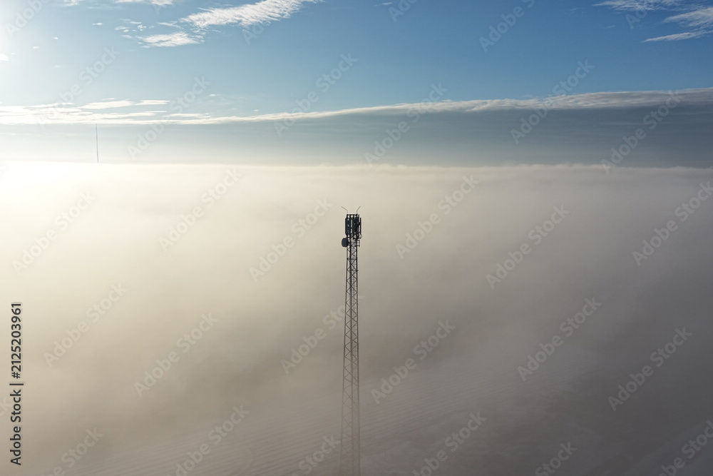 Obraz premium Network transmission tower in minimal foggy landscape