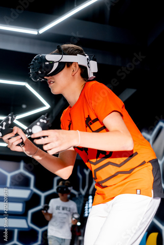 virtual reality game in a helmet with joysticks, a boy playing in a virtual helmet