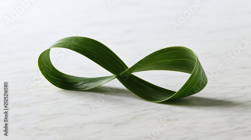 Infinity Symbol of Nature: A single green leaf elegantly forms an infinity symbol, representing endlessness and the cyclical nature of life, set against a subtle, textured background.