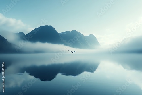 Solitary Bird Soaring Over Tranquil Lake Surrounded by Misty Mountains