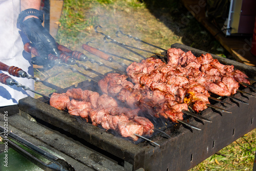 Grilling pieces of meat on skewers over a charcoal grill. Cooking a traditional shashlik over charcoal. Cooking meat on vacation authentic image wallpaper