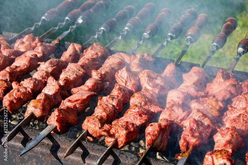 Grilling pieces of meat on skewers over a charcoal grill. Cooking a traditional shashlik over charcoal. Cooking meat on vacation authentic image wallpaper
