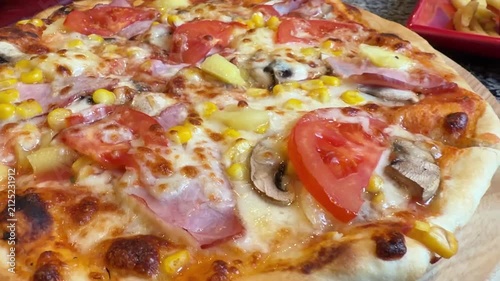 Homemade Pizza with Ham, Tomatoes, Corn and Mushrooms