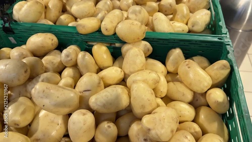 Raw Potatoes in Green Plastic Crates at Supermarket