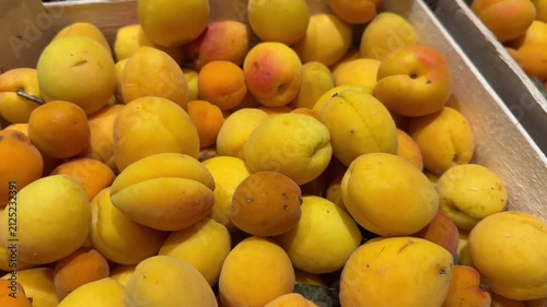 Wooden Crate Filled with Fresh Ripe Apricots at Market