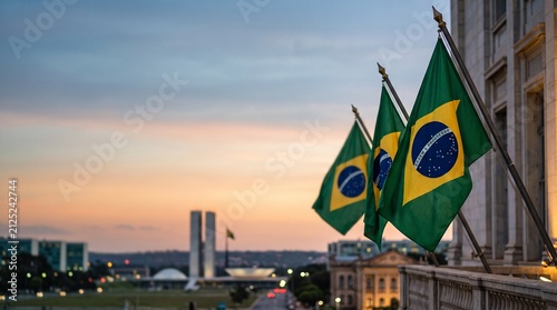 Brazilian flags waving on a building balcony with the National Congress of Brazil in the background at sunset.