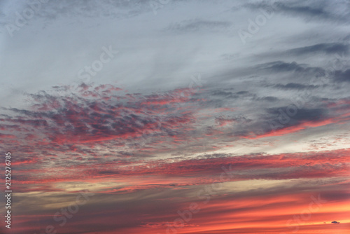 Cloudscape with bright red fluffy clouds in sunset sky