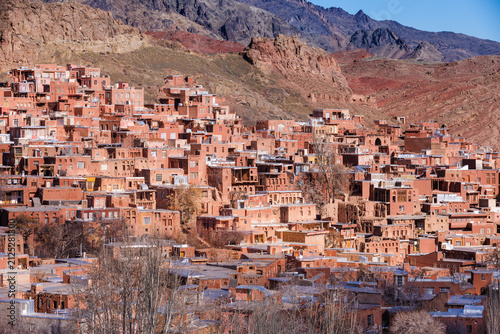 Fotografie Historic Abyaneh village, Iran, with traditional red adobe houses built on a mou