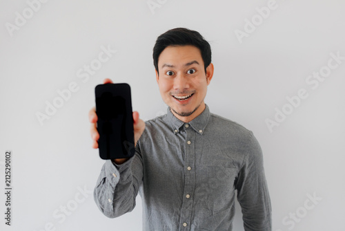 Excited Asian Man Holding Up Blank Smartphone Screen for Advertisement or App Display