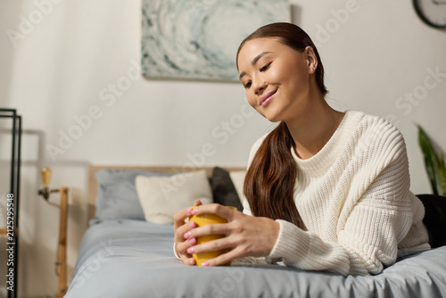 Cuadro en lienzo Cozy moments: young woman enjoying leisure in a tranquil apartment atmosphere