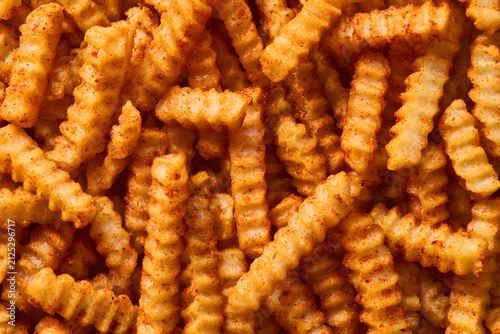 A top view of a stack of crinkle-cut fries, a traditional Cajun dish, serving as the central image.