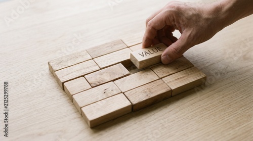 Obraz na plátně Hand typing on wooden keyboard with natural light