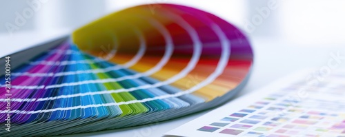 Close-up of a colorful paint swatch fan displaying a spectrum of hues.