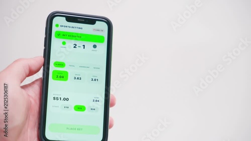 Hand holding smartphone showing sports betting app with live odds close-up 