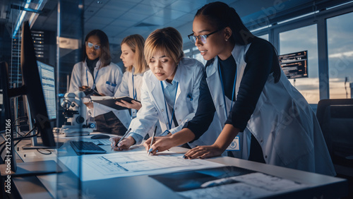 Multinational Female Engineers Collaborating on Research Project in Modern Technology Laboratory