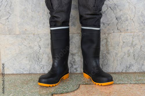 the man wear the safety boots for working