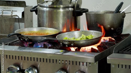 Commercial restaurant kitchen stove cooking various dishes