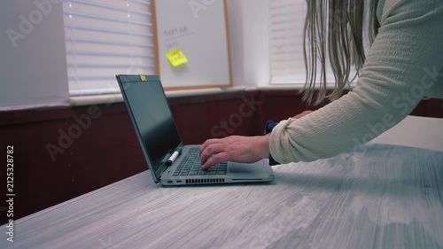 Woman typing on laptop in office