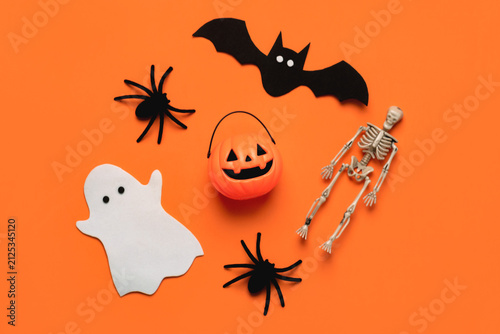 Top view of pumpkin basket with bat,ghost and spiders. Halloween concept background