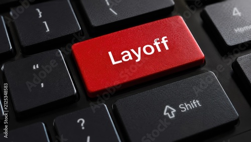 A close-up view of a computer keyboard with a prominent red key labeled Layoff, symbolizing the impact of job loss and economic challenges faced by workers in today's corporate environment.