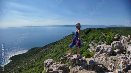 Woman enjoying the panoramic view of Sveti Ivan Beach from the historic Lubenice village on Sveti Ivan Lubenice Beach. A medieval settlement on Cres Island. Croatia of Cres Island in Croatia