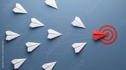 Red paper airplane leading a group of white paper planes towards a target, symbolizing leadership and innovation. Business concept for teamwork, strategy, and achieving goals.