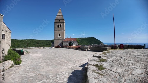 Lubenice on Cres Island, Croatia. Medieval stone houses and parish church overlooking. A village known as starting point of trek to Sveti Ivan Beach or Lubenice Beach, the most famous beach on Cres.