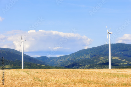 Renewable Energy Wind Turbines in Open Field with Blue Sky