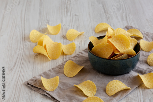 Crunchy Sour Cream and Onion Flavoured Potato Chips in a Bowl, side view.