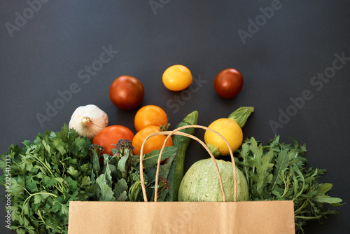 Vegetables dark background with copy space. Grocery basket, package with vegetables. Healthy diet. Vegetables on black background for advertising