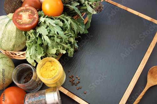 Vegetables dark background with copy space. Healthy meal. Menu, price background. Vegetables on black chalkboard.