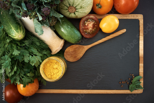 Vegetables dark background with copy space. Healthy meal. Menu, price background. Vegetables on black chalkboard.