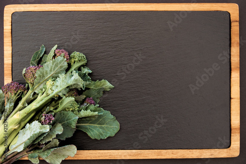 Broccoli on black chalkboard. Vegetables background with copy space