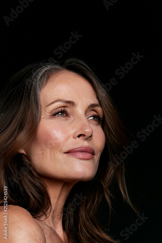glowing mature woman portrait with elegant natural beauty, cinematic headshot of confident middle aged woman with radiant skin, timeless elegant female beauty portrait with soft light 