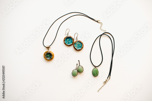 Jewelry made of ceramics. Ceramic earrings and pendant. Turquoise earrings on a white background. Handmade jewelry on a white background.