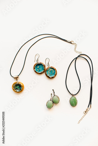 Jewelry made of ceramics. Ceramic earrings and pendant. Turquoise earrings on a white background. Handmade jewelry on a white background.