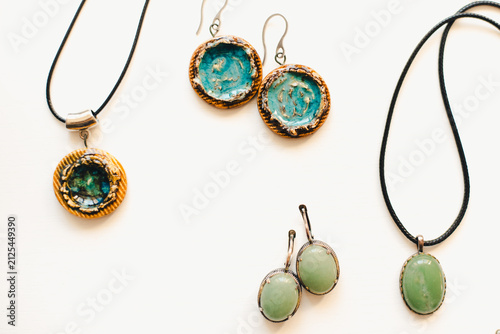 Jewelry made of ceramics. Ceramic earrings and pendant. Turquoise earrings on a white background. Handmade jewelry on a white background.