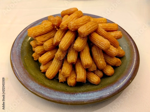 Quadro su tela Tulumba or Balah al-Sham is a typical Turkish dessert made from fried dough and drizzled with sugar syrup