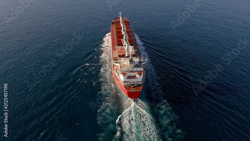 Great cargo ship sailing fast in open waters of the Mediterranean Sea close to the Spanish coast.