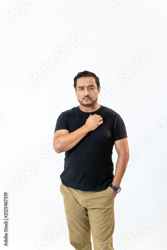Obraz na plátně Latino man showing sincerity and confidence on white