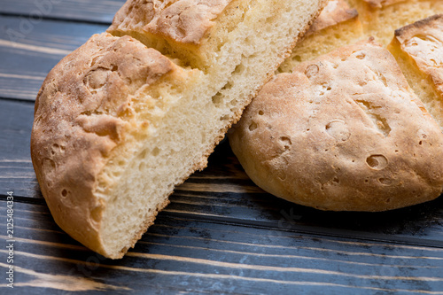 gluten-free bread is cut on a wooden surface with a rustic feel.