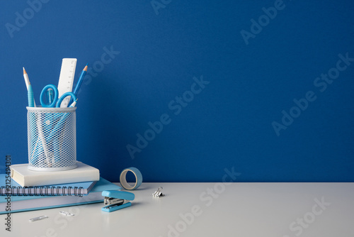 Side view photo of blue stationery and school supplies on a clean desk for back to school study