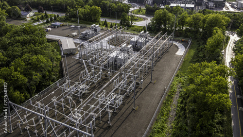 Cuadro en lienzo Aerial view of an electrical substation with power transformers, high-voltage busbars, circuit breakers, and steel structures surrounded by trees in Dover Plains, New York, United States