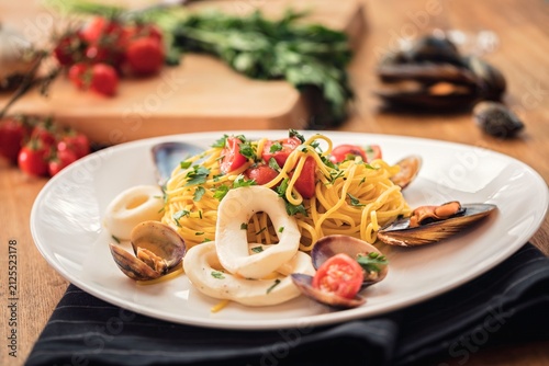 Bild auf Leinwand Artisan pasta tossed with succulent seafood and vibrant tomatoes creating a Medi