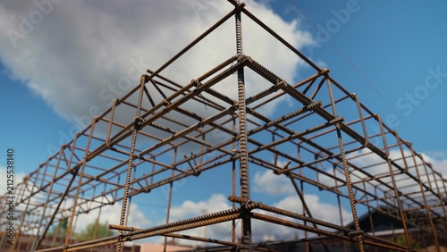 Industrial rebar grid creating a strong framework for concrete pouring, representing construction, engineering, and the beginning of a new structure against a blue sky