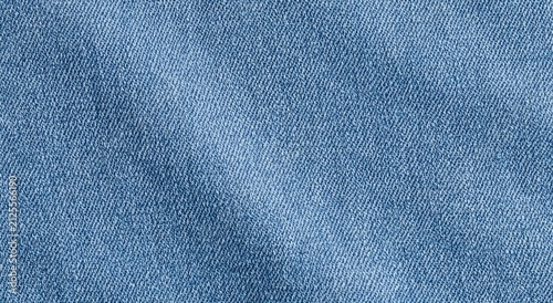 Close-up textured blue fabric with subtle wrinkles and light shading