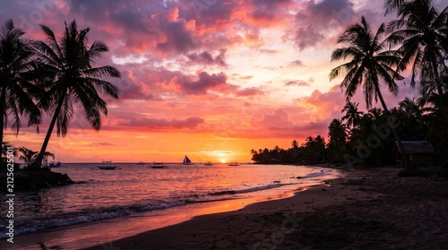 Vibrant tropical sunset over a calm ocean beach with silhouetted palm trees perfect for travel and vacation themes serene natural landscape